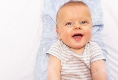 Portrait of cute baby boy sleeping on bed