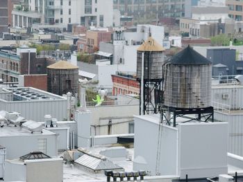 High angle view of water tanks on roof in city