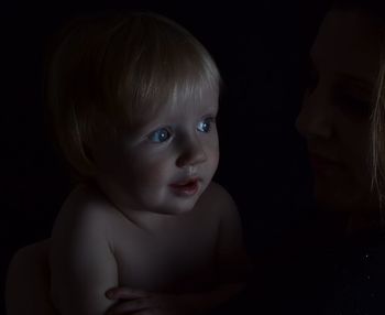 Close-up of curious boy in darkroom