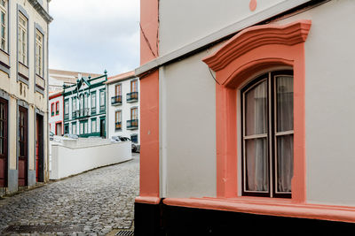 Street amidst buildings against sky