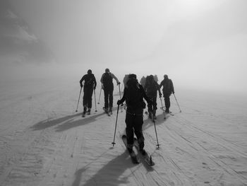 Rear view of people cross-country skiing