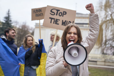 Portrait of young woman holding map