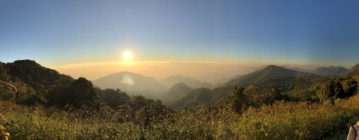 Scenic view of mountains against bright sun