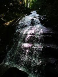 Water flowing through rocks in forest