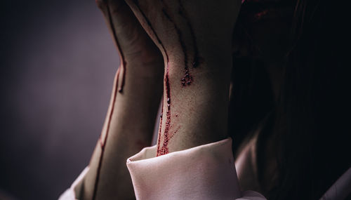 Midsection of woman with blood on hands