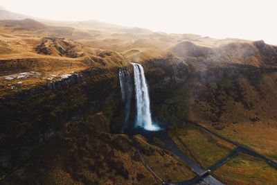 Scenic view of waterfall against sky