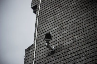 Low angle view of security camera on building