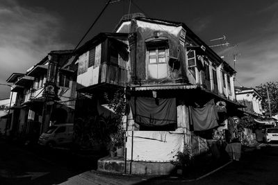 Old building by street in city against sky