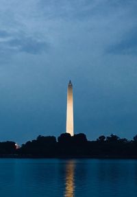 View of monument in city against cloudy sky
