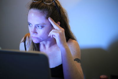 Woman using laptop while sitting at home