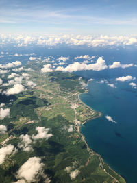 Aerial view of landscape and sea against sky