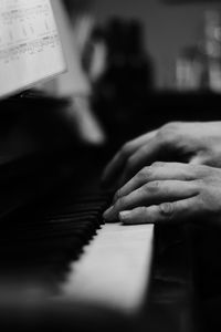 Close-up of hands playing piano