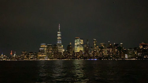 Illuminated buildings against sky at night