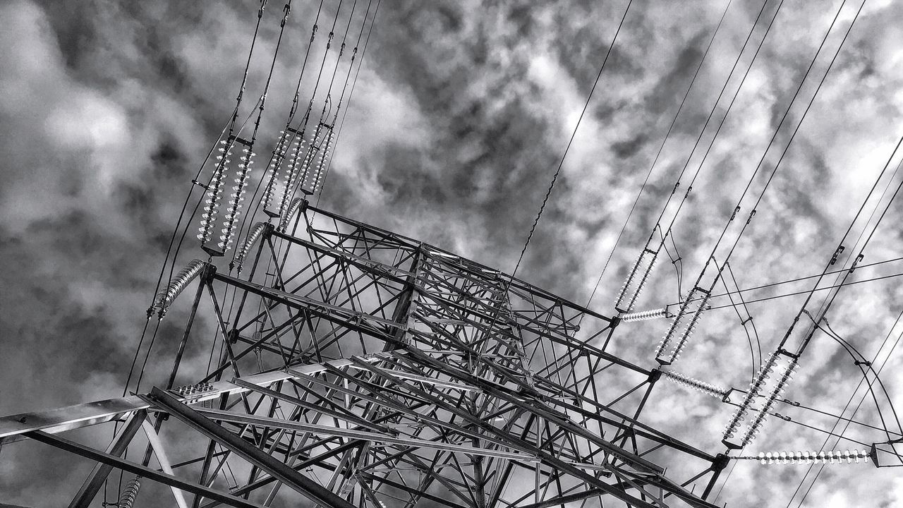 low angle view, sky, cloud - sky, cloudy, day, outdoors, built structure, tall - high, arts culture and entertainment, no people, weather, cloud, complexity, ferris wheel, amusement park, fuel and power generation, nature, amusement park ride, architecture, development