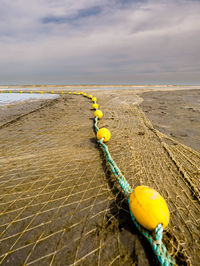 Closeup of a fishnet at the beach waiting for high tide