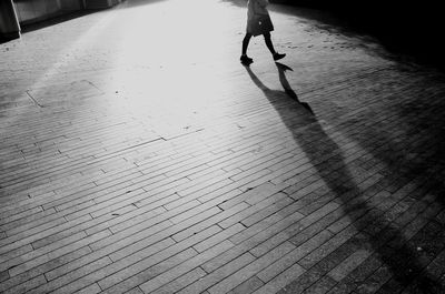 Low section of woman walking on footpath