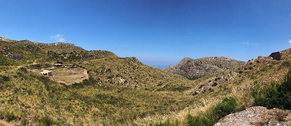 Scenic view of mountains against clear blue sky