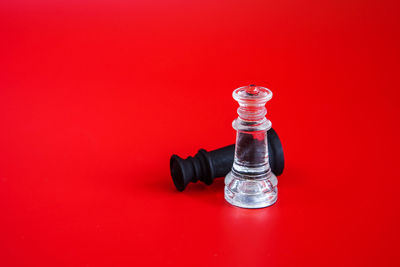 High angle view of chess pieces against red background