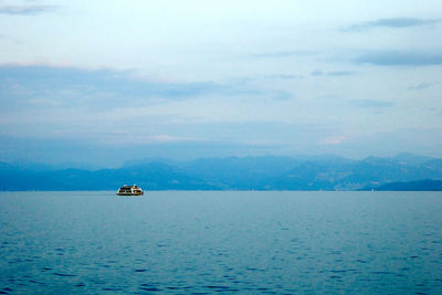 Boat sailing on sea against sky