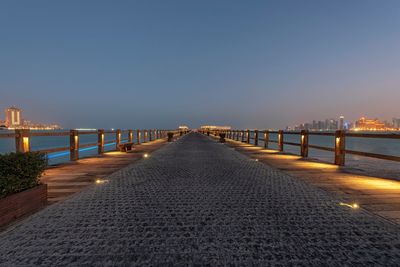 Bridge over sea against clear sky