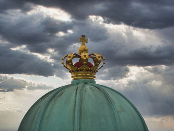 Low angle view of statue against temple against sky