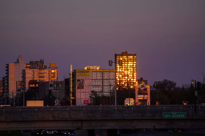 Illuminated buildings against sky at night in city