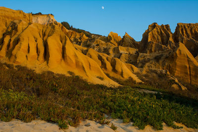 Panoramic view of rocky mountains against clear sky