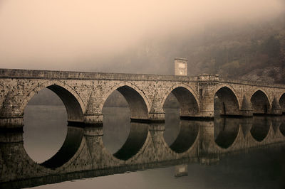 Old  arch bridge over the river drina in višegrad against sky