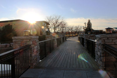 Walkway by building against sky