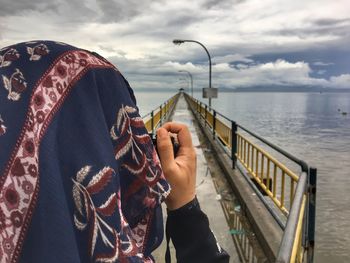 Person taking photographs on pier