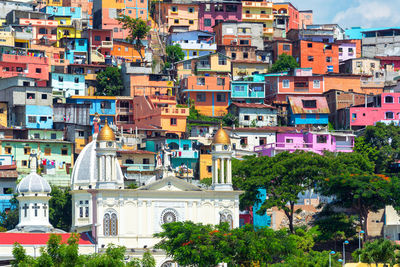 Church of santo domingo de guzman against colorful buildings in city