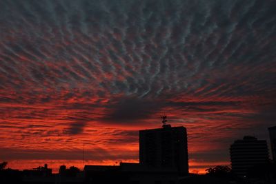 Silhouette built structure against sunset sky