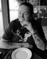 Portrait of woman sitting on table