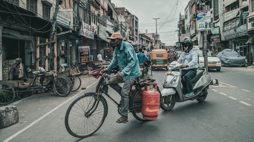 Bicycles on street against buildings in city