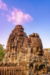 Low angle view of rock formation against sky