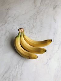 High angle view of yellow fruit on white surface