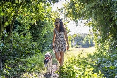 Woman with dog walking at park