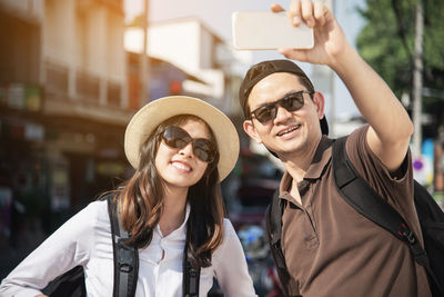 Man and woman standing on street