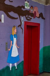 Clothes hanging on closed door in front of wall