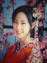 Portrait of smiling young woman with flowers