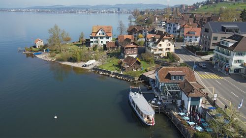 Boats in river with buildings in background