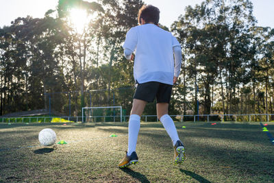 Child soccer practice on a sunny day. colored cones demarcating the practice to use the ball. 