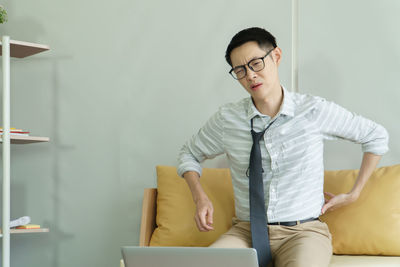 Portrait of young man sitting on table