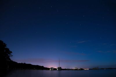 Scenic view of lake against sky at night
