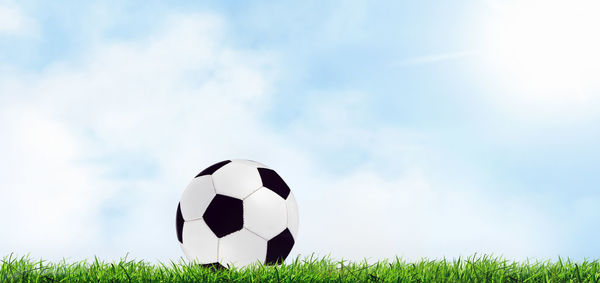 Low angle view of soccer ball on field against sky