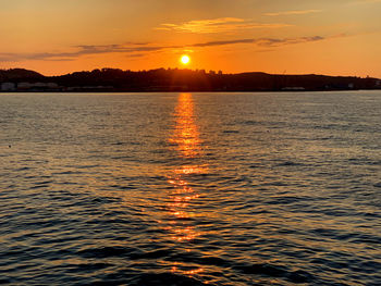 Scenic view of sea against romantic sky at sunset