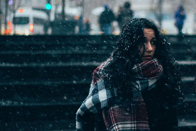 Side view of woman standing on snow