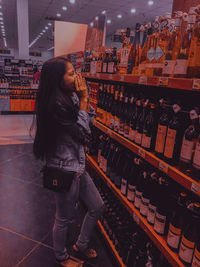 Side view of woman standing in store