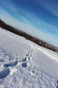 Scenic view of snow field against blue sky