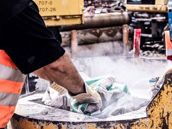 Midsection of manual worker working at factory